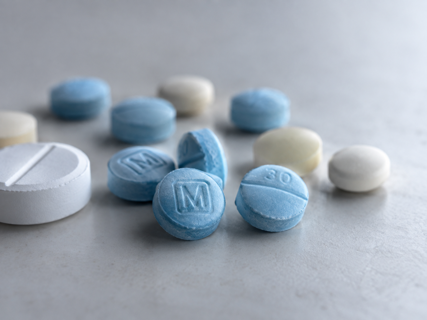 Assorted unidentified pills representing counterfeit pill risks